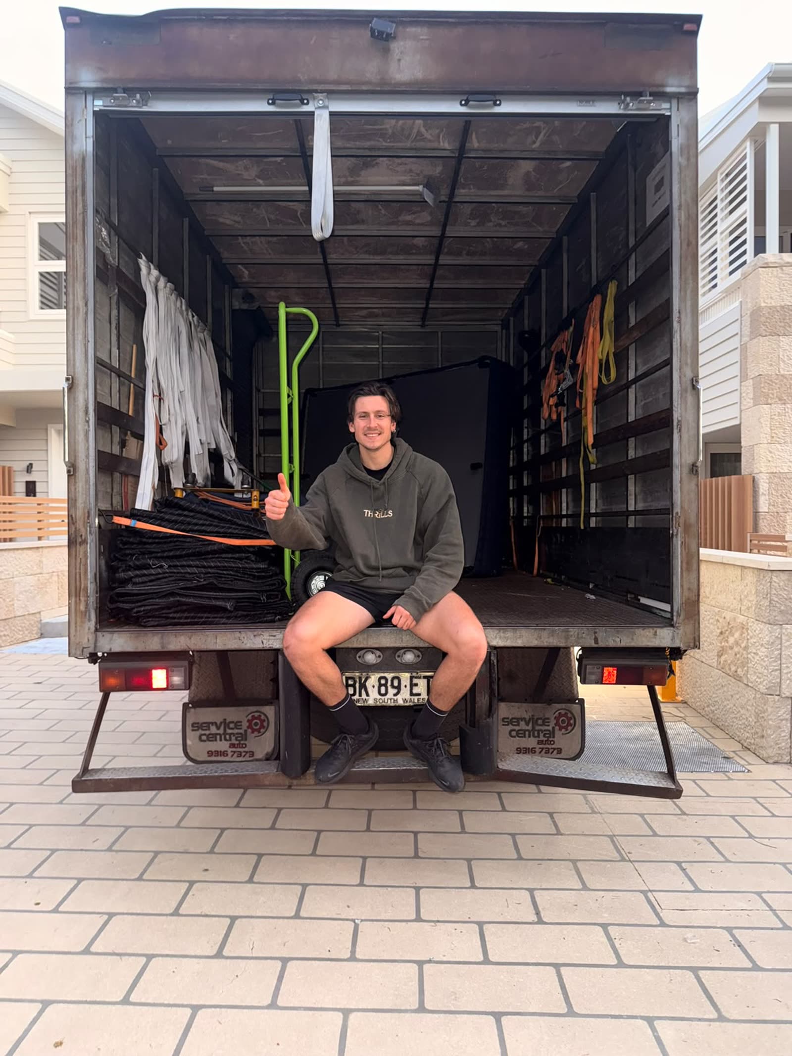 LuckyMove crew member on the back of a fully equipped moving truck